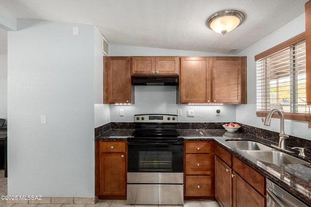 kitchen featuring a sink, appliances with stainless steel finishes, under cabinet range hood, and dark stone counters