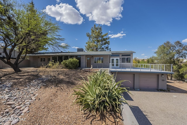 63960 E Condalia Pl, Saddlebrooke, AZ 85739 - single story home featuring a garage, driveway, and french doors