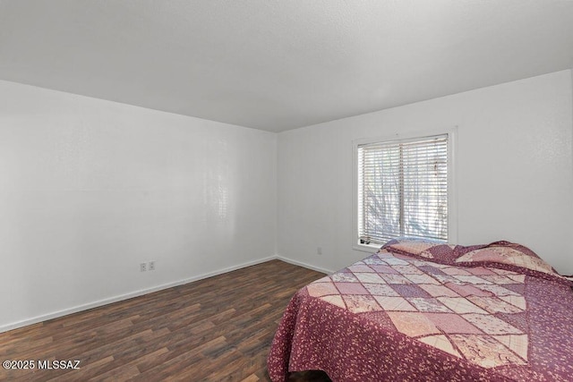 7420 N Oliver Ave, Tucson, AZ 85741 - bedroom with baseboards and dark wood-style flooring