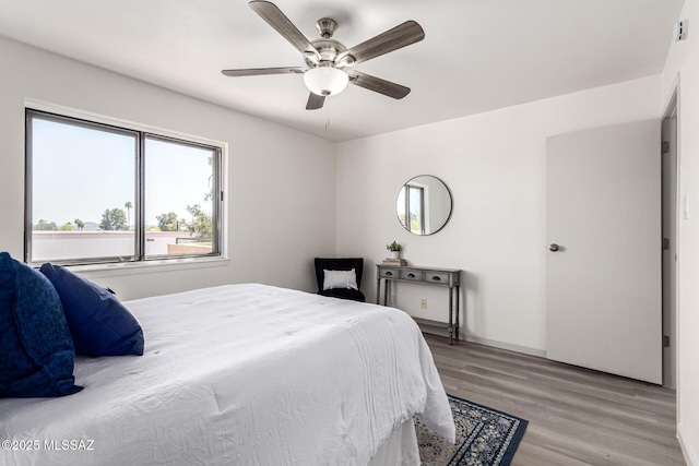 bedroom featuring a ceiling fan and light wood finished floors