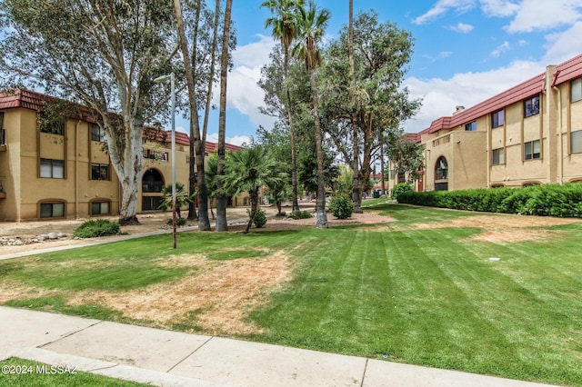 view of community featuring a lawn and a residential view
