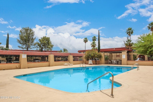 pool featuring a patio and fence