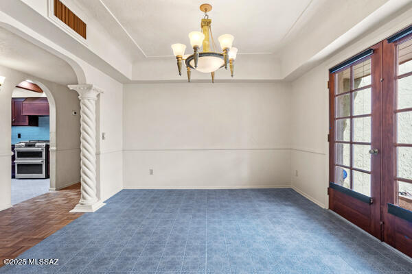 4361 N Wilmot Rd, Tucson, AZ 85750 - empty room featuring decorative columns, a tray ceiling, visible vents, and arched walkways