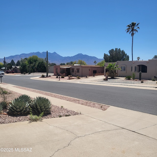 view of road with a mountain view and sidewalks