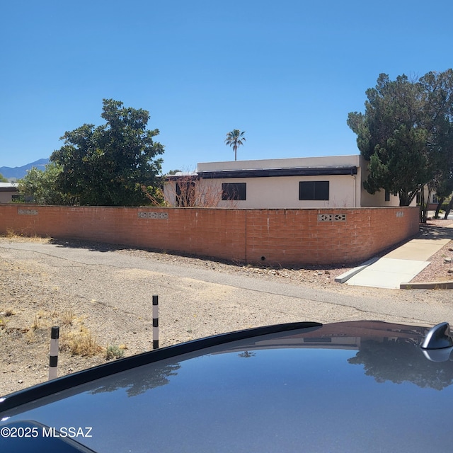 exterior space with fence and a mountain view