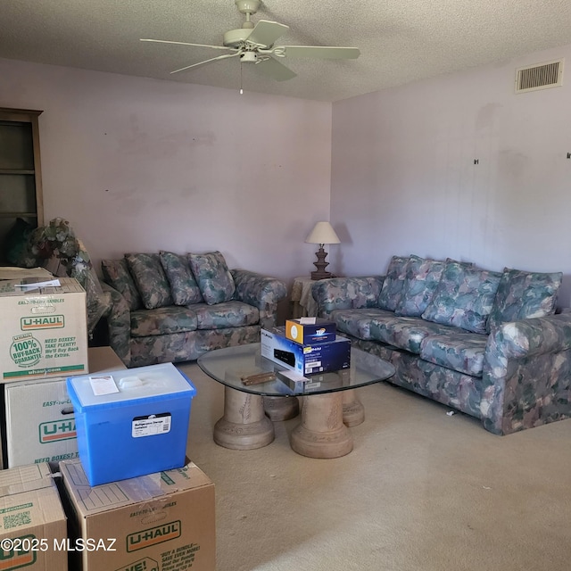 carpeted living area featuring a ceiling fan, a textured ceiling, and visible vents
