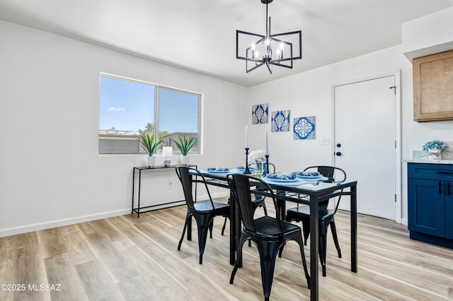 7555 E 25th St, Tucson, AZ 85710 - dining space with an inviting chandelier, light wood-style floors, and baseboards