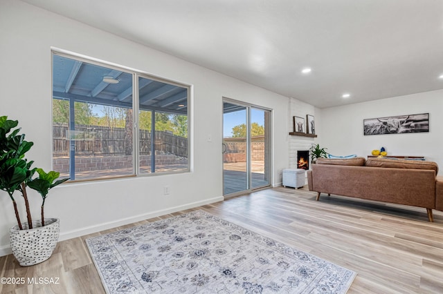 7555 E 25th St, Tucson, AZ 85710 - living room with a brick fireplace, recessed lighting, baseboards, and light wood-type flooring