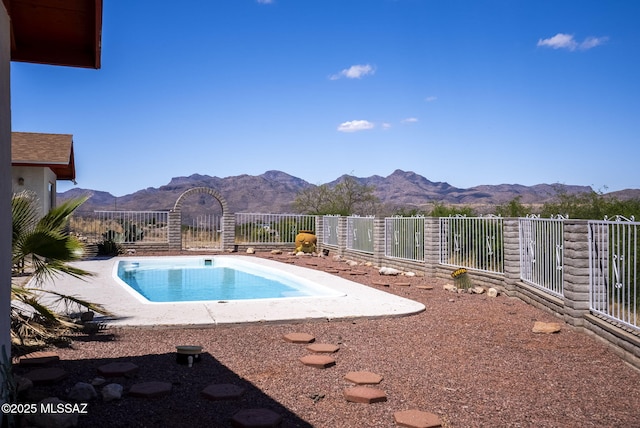 view of swimming pool featuring fence, a fenced in pool, and a mountain view