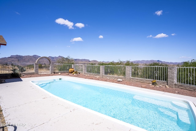 view of pool with a fenced in pool and a mountain view