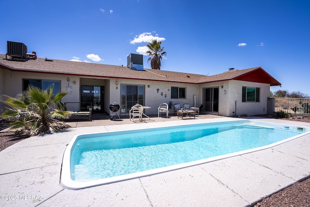 back of house with a patio, stucco siding, cooling unit, and an outdoor pool