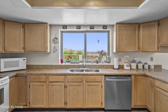 kitchen with a sink, light countertops, white appliances, and a textured ceiling