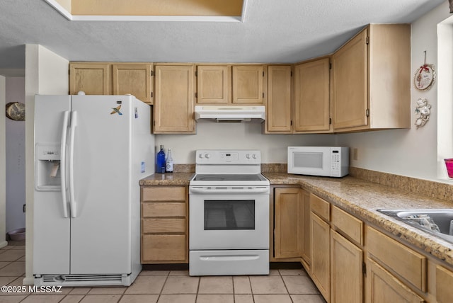 kitchen with a textured ceiling, light tile patterned floors, a sink, under cabinet range hood, and white appliances