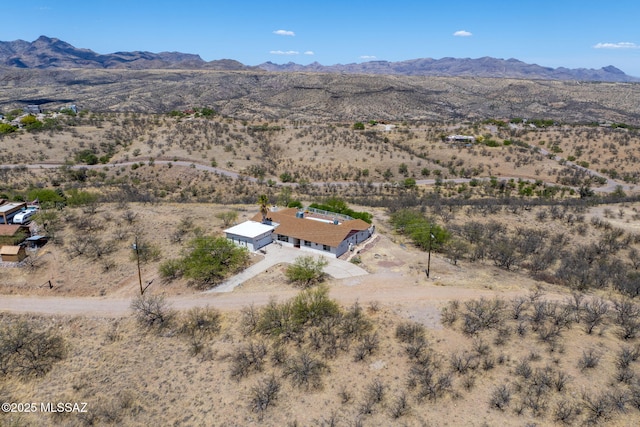 drone / aerial view with a rural view, a mountain view, and view of desert