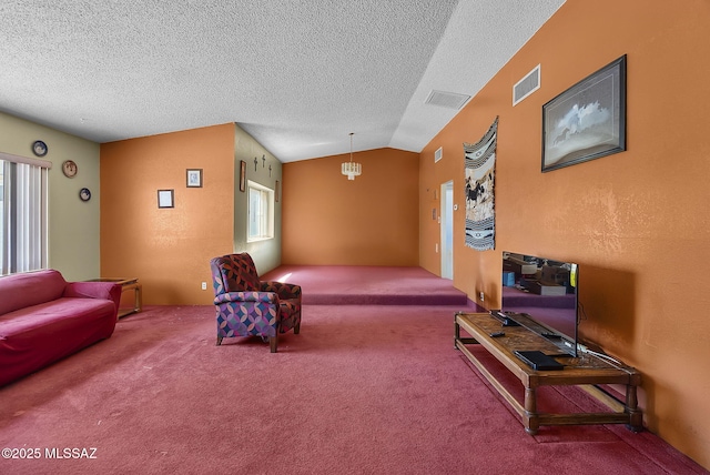 living room with carpet floors, a textured ceiling, and visible vents