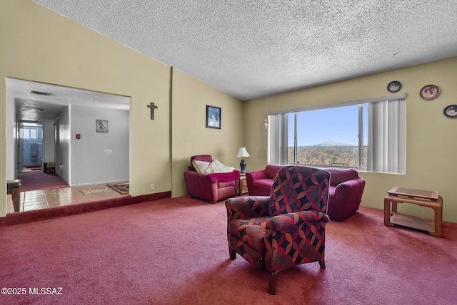 living area featuring carpet floors, a textured ceiling, vaulted ceiling, visible vents, and a mountain view