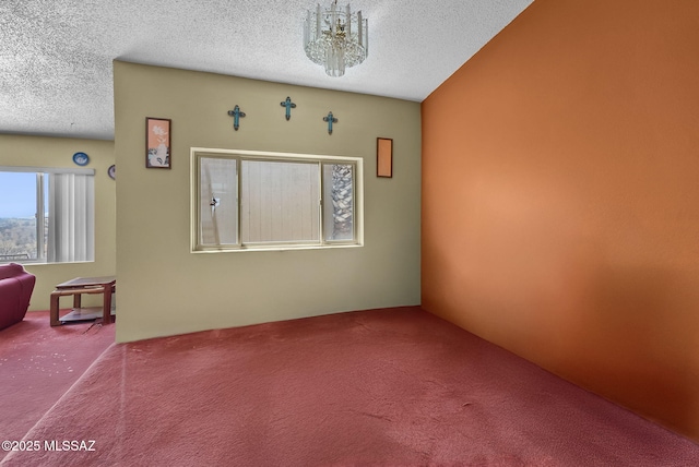 unfurnished room with a textured ceiling and carpet