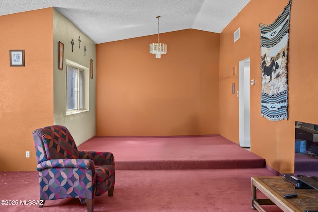 living area with a notable chandelier, carpet floors, a textured ceiling, lofted ceiling, and visible vents