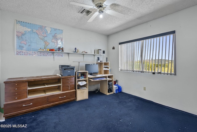 carpeted office with visible vents, a ceiling fan, and a textured ceiling
