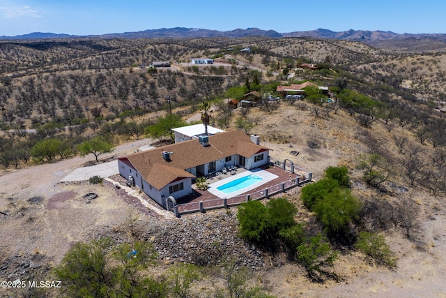 drone / aerial view with view of desert and a mountain view