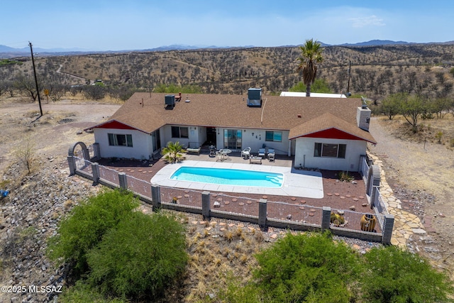 view of pool featuring a fenced in pool, a fenced backyard, a patio area, and a mountain view