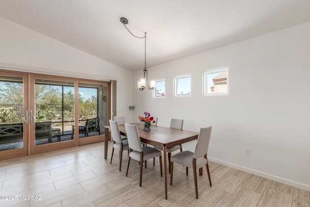13795 N Buckhorn Cholla Dr, Marana, AZ 85658 - dining space with a chandelier, vaulted ceiling, baseboards, and light wood-style floors