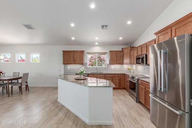 13795 N Buckhorn Cholla Dr, Marana, AZ 85658 - kitchen with stainless steel appliances, a sink, brown cabinetry, backsplash, and recessed lighting