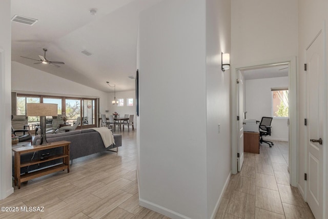 13795 N Buckhorn Cholla Dr, Marana, AZ 85658 - hall featuring high vaulted ceiling, a desk, baseboards, and light wood-style flooring