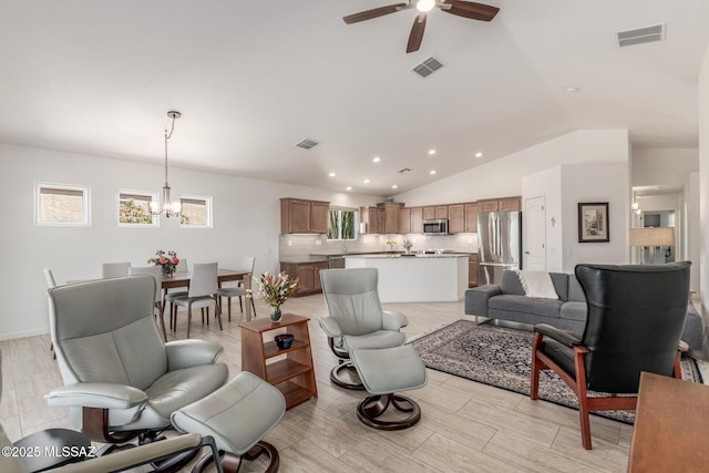 13795 N Buckhorn Cholla Dr, Marana, AZ 85658 - living area featuring vaulted ceiling, a ceiling fan, a chandelier, recessed lighting, and light wood-style flooring