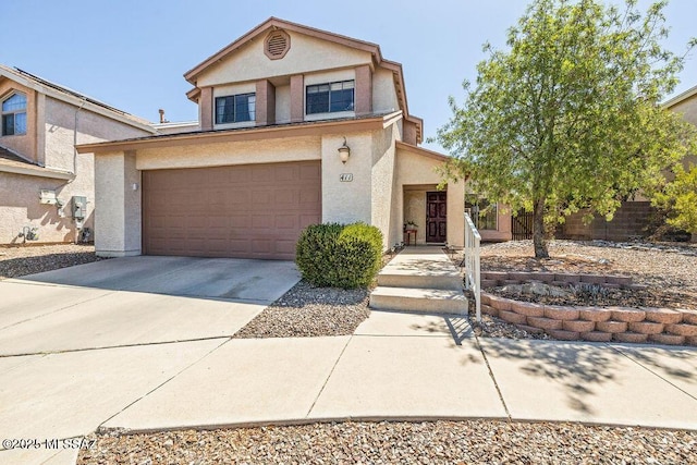 traditional-style home featuring an attached garage, stucco siding, and driveway