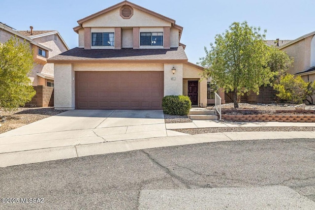 traditional-style house featuring stucco siding, driveway, and a garage