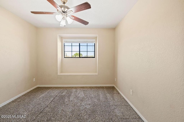 carpeted spare room with baseboards and ceiling fan