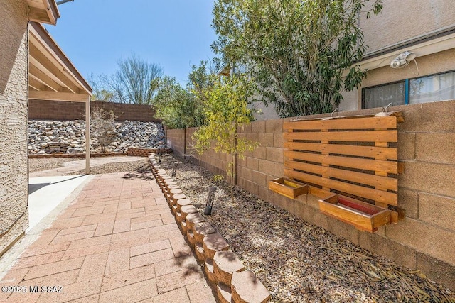 view of yard featuring a fenced backyard and a patio area
