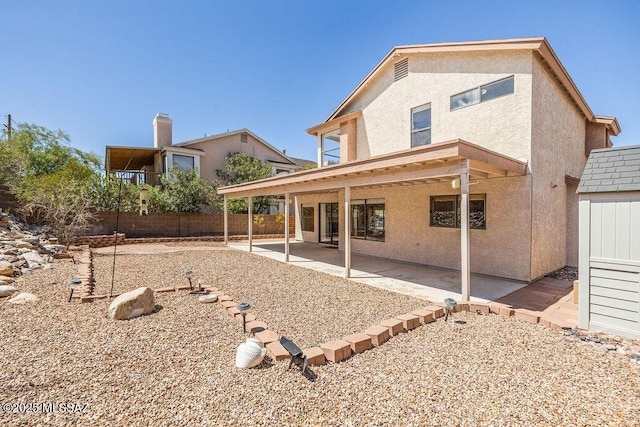 back of house featuring fence, a patio, and stucco siding