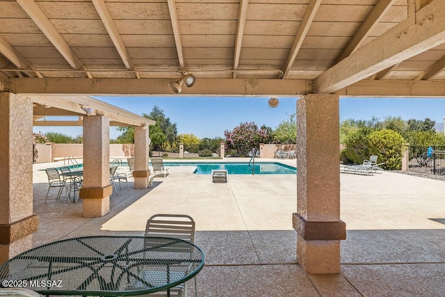 view of pool featuring outdoor dining area, a patio area, a fenced backyard, and a fenced in pool