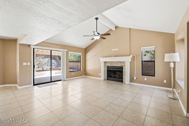 unfurnished living room with light tile patterned floors, beam ceiling, and a ceiling fan