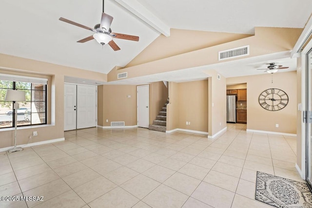 unfurnished living room with ceiling fan, light tile patterned floors, visible vents, and beam ceiling