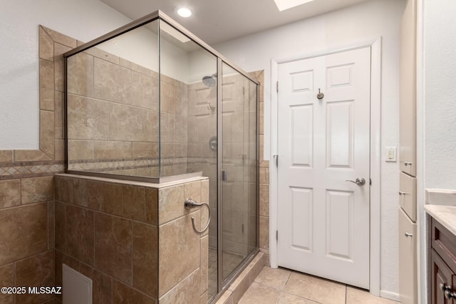 full bath featuring vanity, recessed lighting, tile patterned flooring, and a stall shower