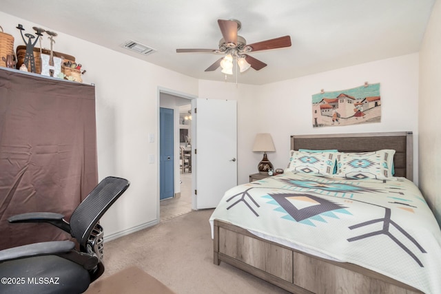 bedroom featuring visible vents, a ceiling fan, and light colored carpet