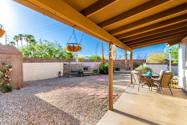 view of patio with a fenced backyard and outdoor dining space