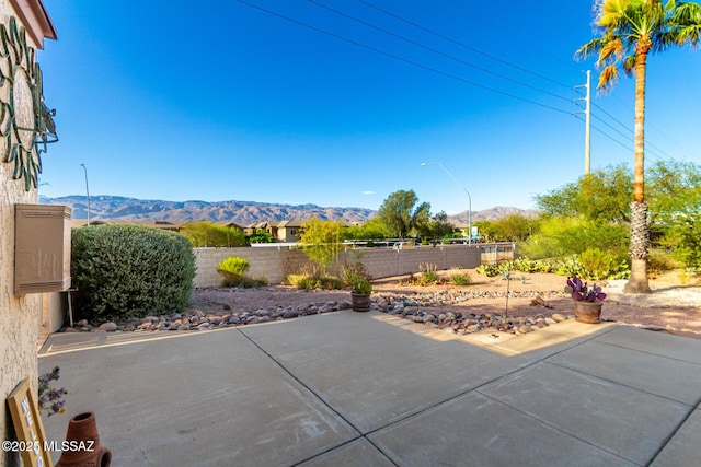view of patio / terrace featuring a fenced backyard and a mountain view