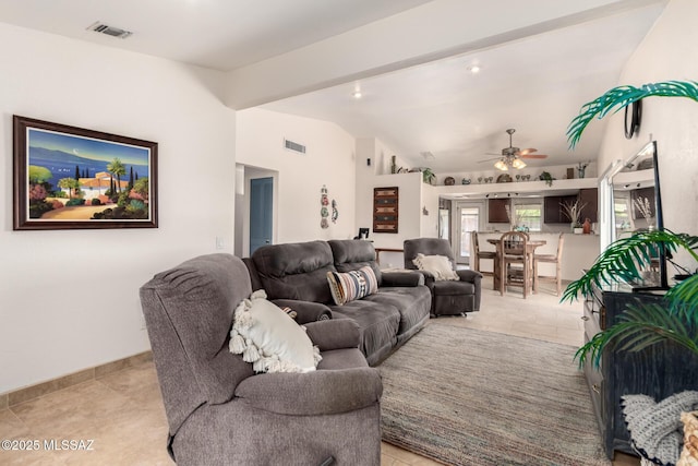 living room featuring a ceiling fan, visible vents, light tile patterned floors, and lofted ceiling