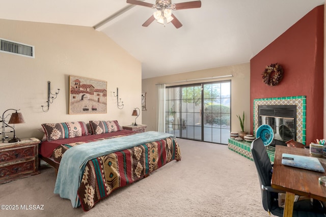 carpeted bedroom with access to outside, ceiling fan, lofted ceiling with beams, a tile fireplace, and visible vents