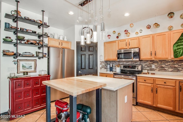 kitchen with backsplash, stainless steel appliances, light tile patterned floors, and light brown cabinets