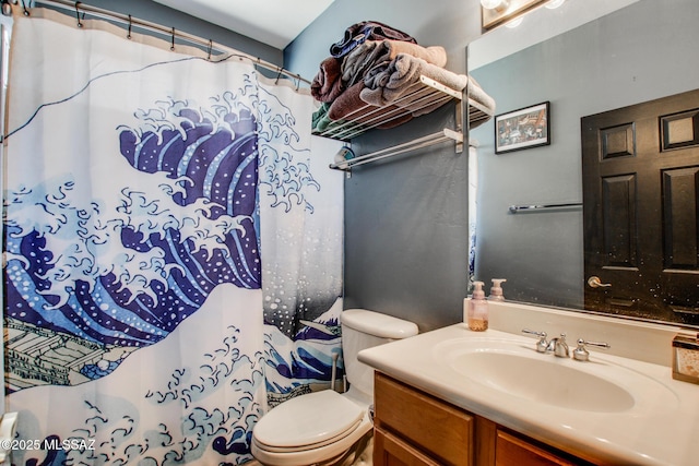 bathroom featuring vanity, toilet, and a shower with shower curtain