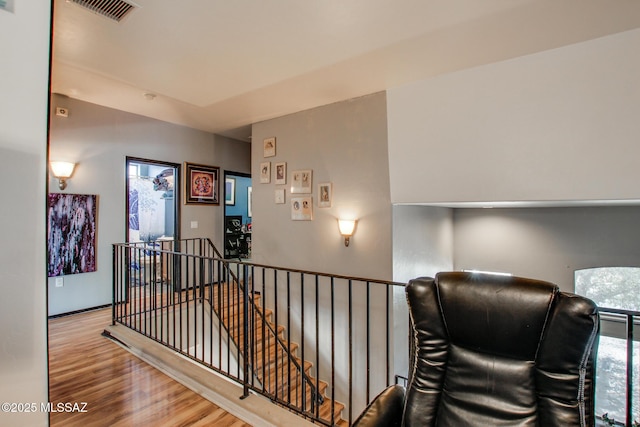 stairs featuring visible vents and wood finished floors