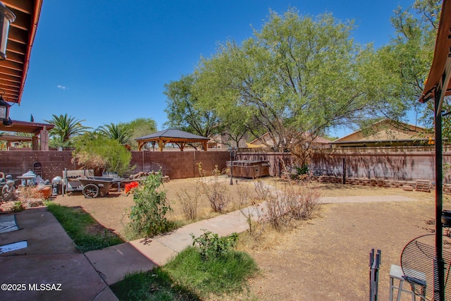 view of yard featuring a patio, a gazebo, and a fenced backyard