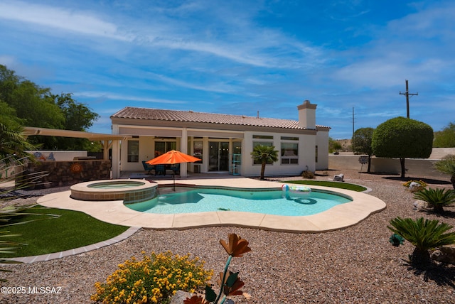 view of swimming pool featuring a patio and a pool with connected hot tub