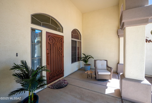view of front facade with a tiled roof, an attached garage, concrete driveway, and stucco siding