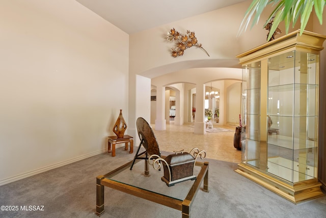 interior space featuring arched walkways, baseboards, and a chandelier